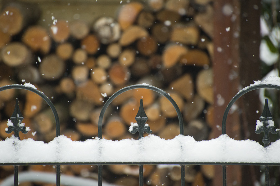 Sneeuw valt op een hekwerk